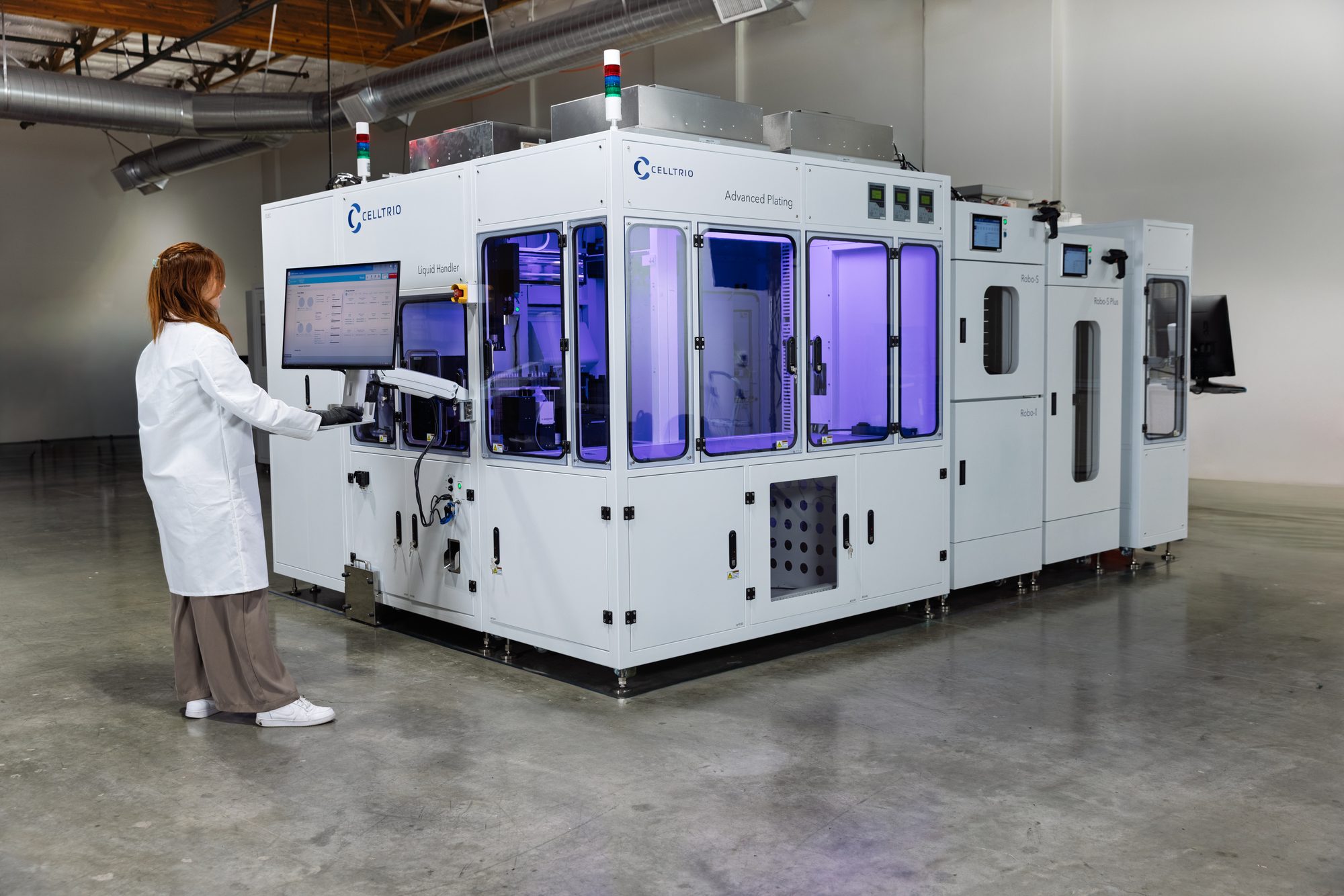 Scientist operating a RoboCell system from its Bioflow workstation